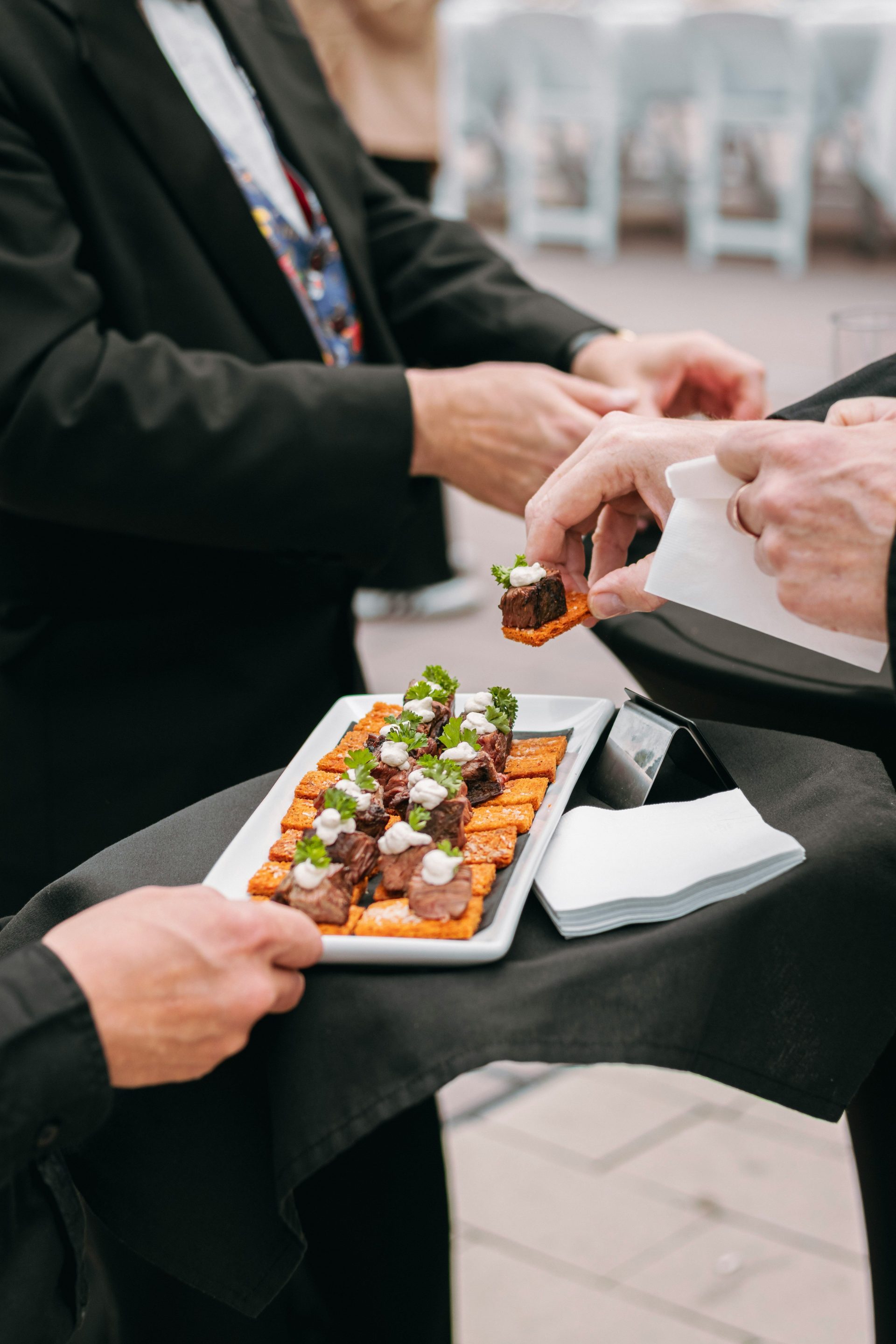 People are serving appetizers at an event.