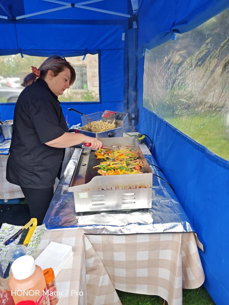 Chef preparing fresh Mediterranean meats on a professional griddle for catering.