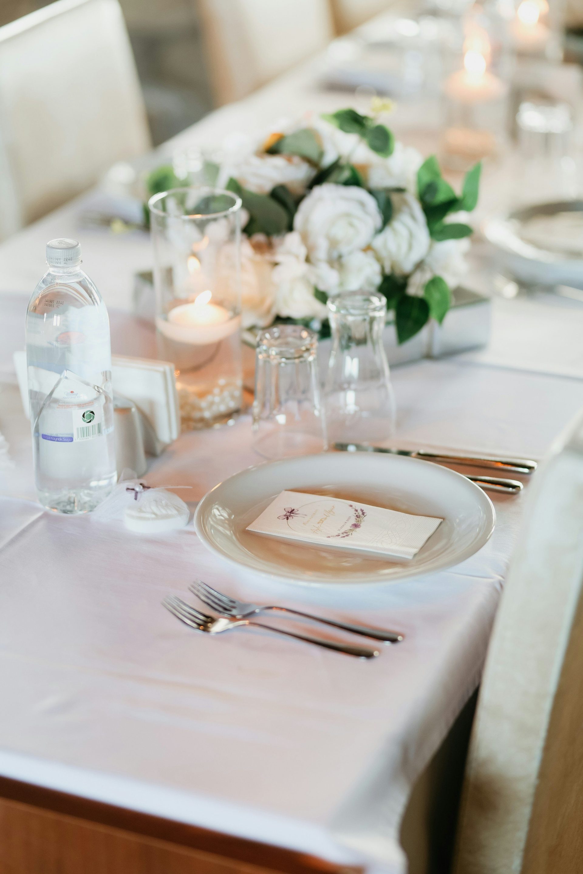 A table setting with floral arrangement and candles